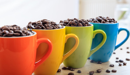 Cups full of coffee beans
