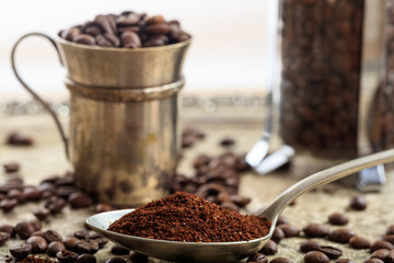 Metal cup with coffee beans