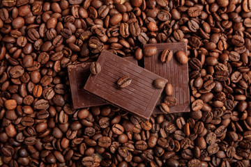Chocolate on coffee beans background