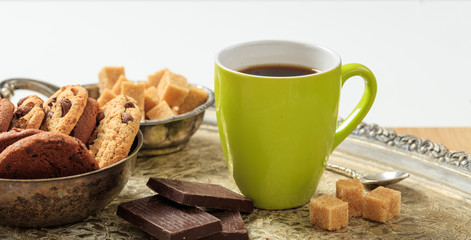 A cup of coffee on an old tray