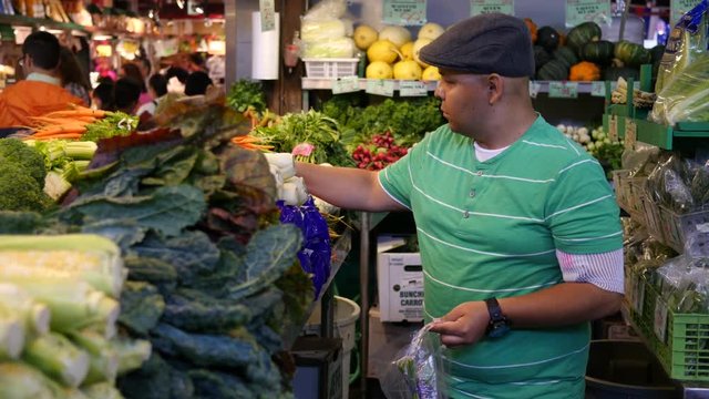 Man buying vegetables in market