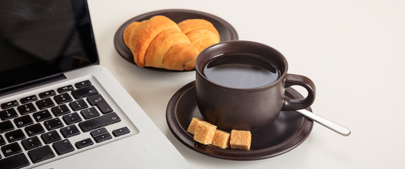 Cup of coffee and a laptop