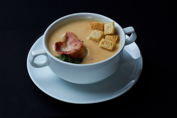 Delicate soup of the French / Italian cuisine. soup with peas, pumpkin, bacon, croutons.