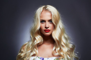 Fototapeta premium luxury beautiful young woman with healthy curl blond hair. long wavy hair girl with make-up