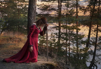 Young woman with a sword praying © Alexey Kuznetsov