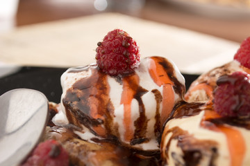 Fresh, golden pancakes with fruit and cream