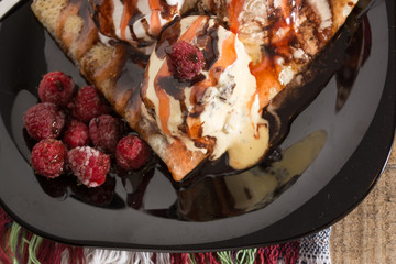 Fresh, golden pancakes with fruit and cream