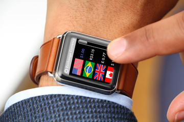 Businessman checking exchange currency through a smart watch app