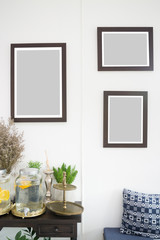 Room interior with frames on white wall