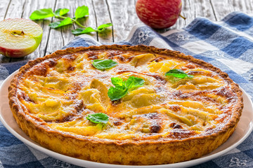 apple pie sprinkled with icing sugar decorated with mint leaves