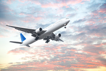 Fototapeta na wymiar Aeroplane flying in sunset sky with beautiful cloud