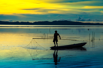 Fototapeta na wymiar Beautiful sky and Silhouettes of fisherman.