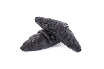Black croissant of active charcoal on white background