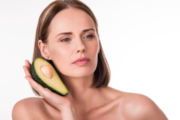 Attractive young woman with avocado