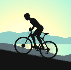 Fototapeta premium cycle races in mountains silhouette on a background nature