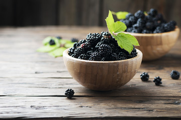 Sweet wild blackberry on the wooden table