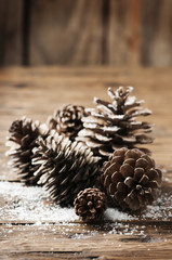Christmas card with cones on the wooden table