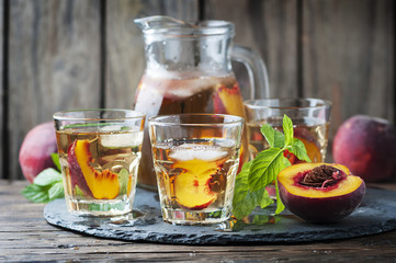 Cold healthy tea with peaches and mint