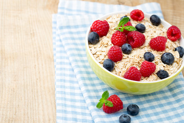 Oatmeal porridge with berries. Raspberries and blueberries.