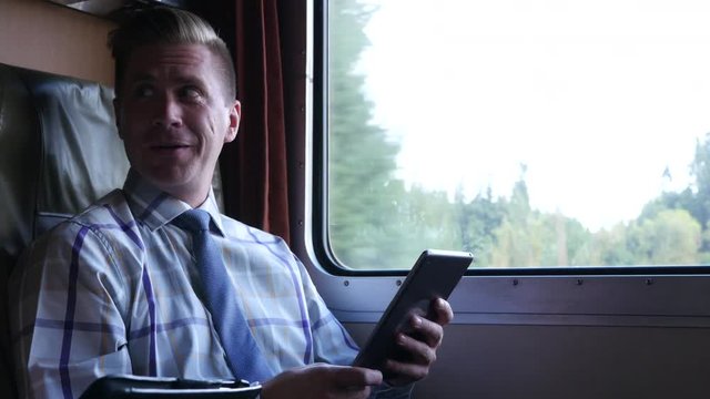 Man using tablet on train