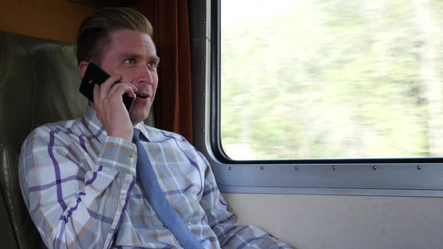 Man using cellphone on train