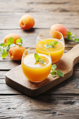 Healthy apricot juice with mint on the wooden table