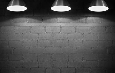 Brick wall with three lamp bulb, black and white.
