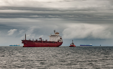 Ship at sea against a dramatic sky.