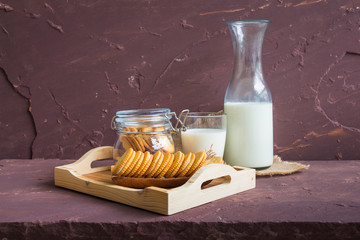 Milk with sandwich cracker on brown stone table over stone grunge background