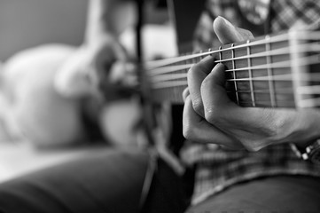 Fototapeta premium playing acoustic guitar, barre chord,selective focus,black and w