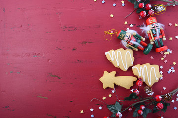 Christmas background with ornaments on red wood table.