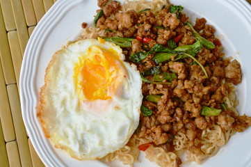 instant noodle topping spicy stir fried chop pork and basil leaf with egg