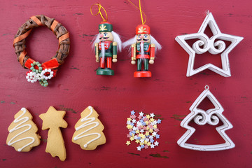 Christmas background with ornaments on red wood table.