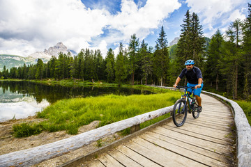 Fototapeta premium Mountain biking in the Dolomites, Misurina, Italy
