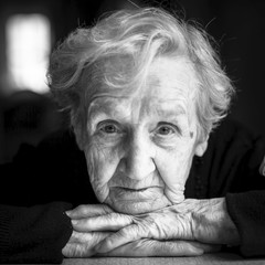 Closeup black and white portrait of an elderly woman.