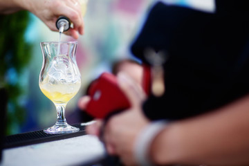 Bartender preparing cocktail for guests