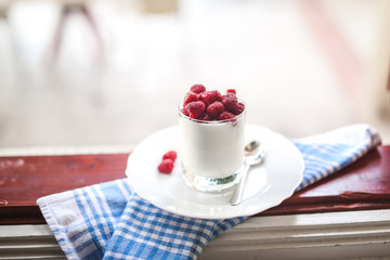 healthy breakfast : yogurt and fresh raspberries