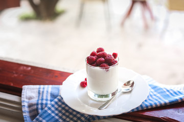 healthy breakfast : yogurt and fresh raspberries