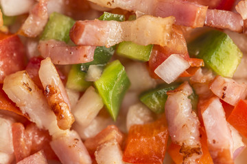 Raw ingredients close up on an abstract vegetables and bacon food texture background