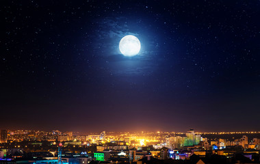 City landscape at nigh with moon. Elements of this image furnished by NASA. © Tryfonov