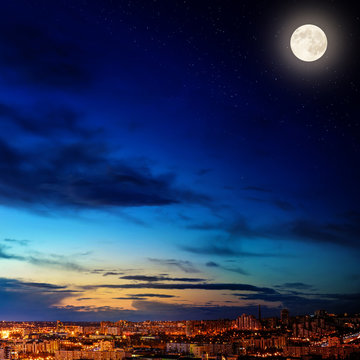 City landscape at nigh with moon. Elements of this image furnished by NASA.