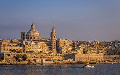 Obraz na płótnie Canvas Valletta, Malta - The beautiful St.Paul's Cathedral and the ancient city of Valletta at sunset with clear blue sky