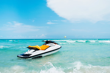 Blue sea and a jet ski floating on the sea, with a blue sky back - Powered by Adobe