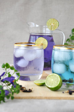 Glass of Butterfly Pea Drinks with Jar on Background