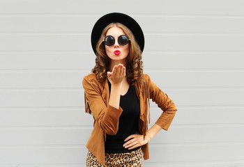 Fashion lifestyle portrait woman sends air sweet kiss wearing a