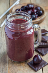Black forest smoothie with cherry, almond milk and cacao, vertical