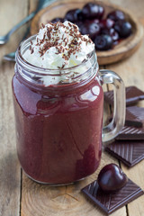 Black forest smoothie with cherry, almond milk and cacao, vertical