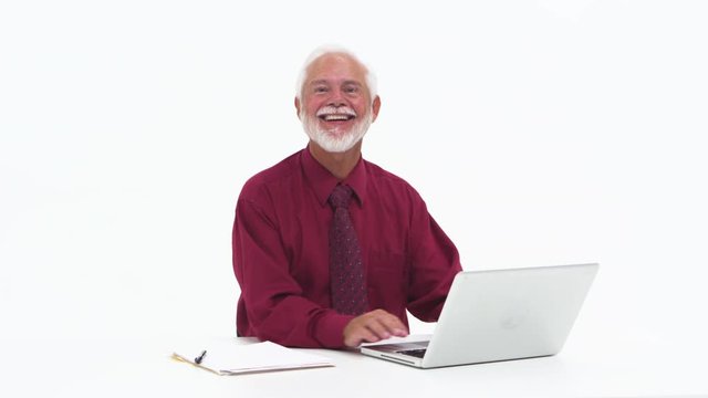 Senior elderly man using laptop and smiling