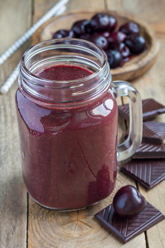 Black forest smoothie with cherry, almond milk and cacao, vertical