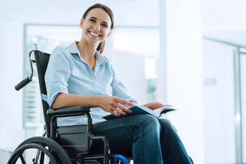 Smiling young woman in wheelchair